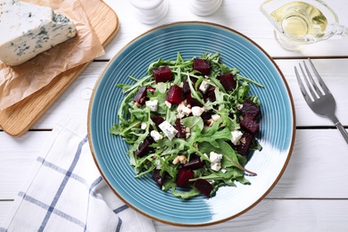 Photo of Fresh delicious beet salad on white wooden table, flat lay