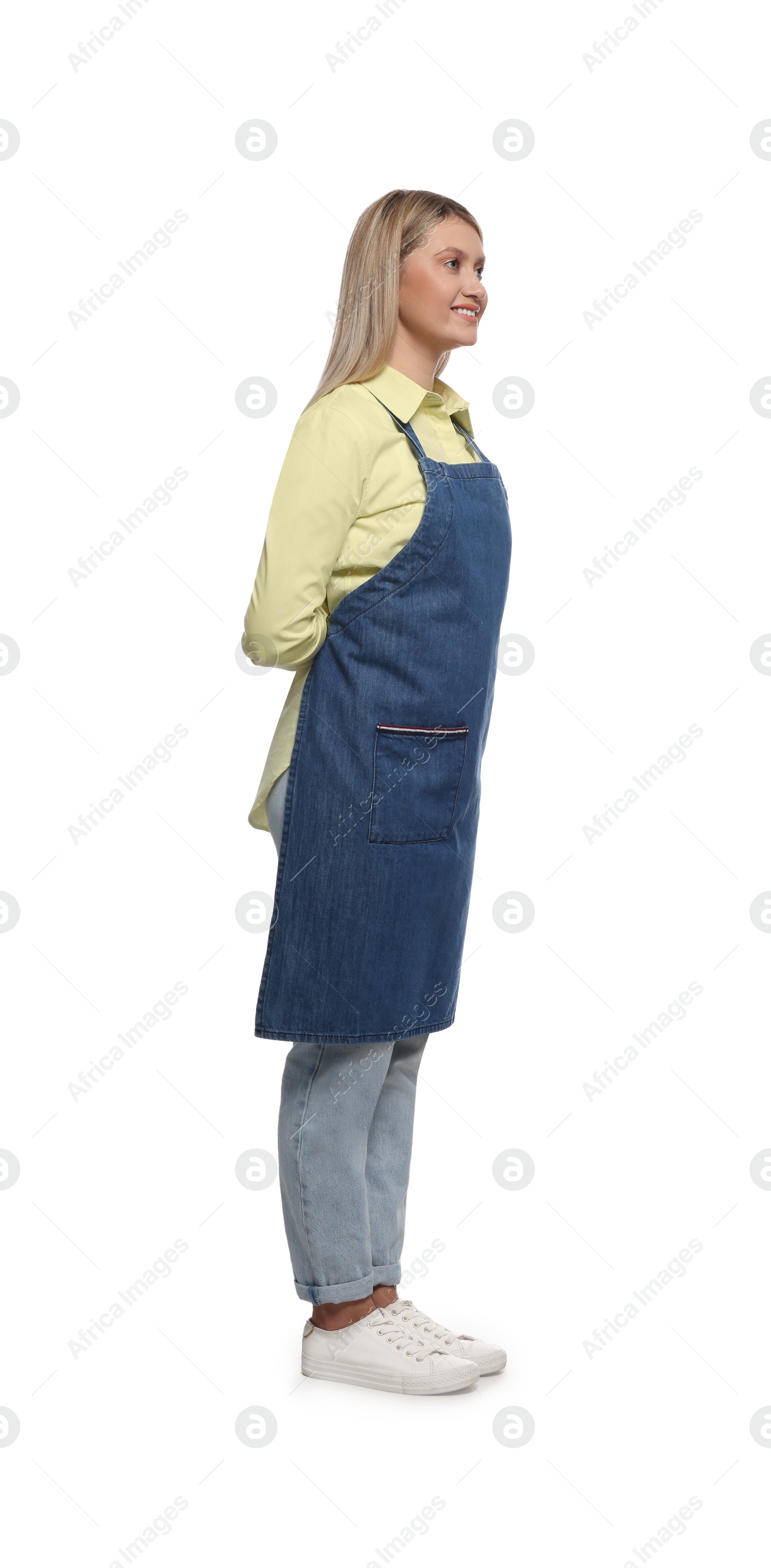 Photo of Beautiful young woman in denim apron on white background