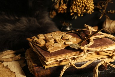 Photo of Many wooden runes and old books on altar