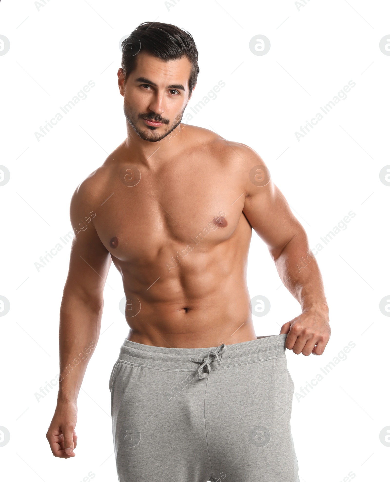 Photo of Young man with slim body on white background