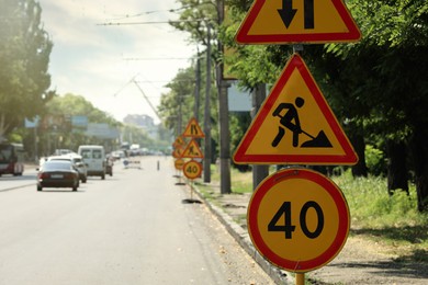 Photo of Traffic signs on city street. Road repair