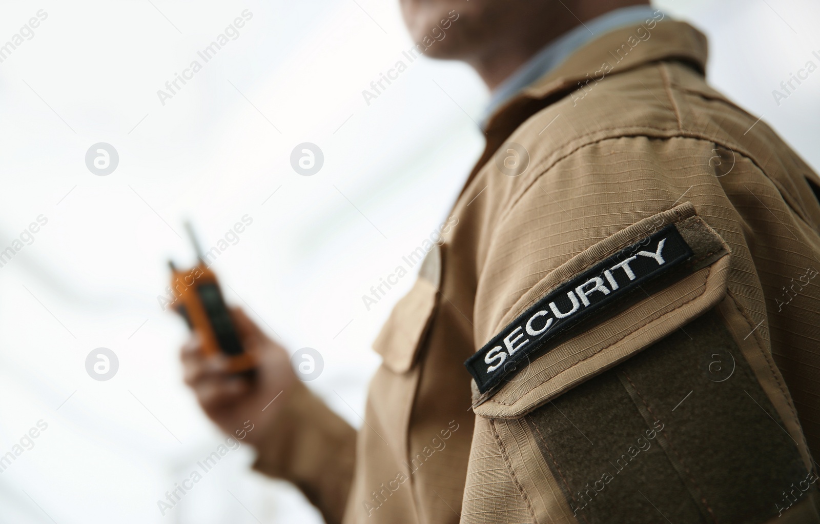 Photo of Chevron with word SECURITY on guard's uniform on light background, closeup