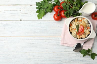 Photo of Delicious chicken risotto served on white wooden table, flat lay. Space for text