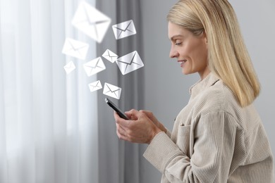 Image of Smiling woman with smartphone chatting indoors. Many illustrations of envelope as incoming messages over device