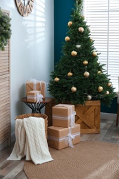 Photo of Beautiful decorated Christmas tree in living room