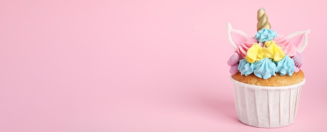 Image of Cute sweet unicorn cupcake on pink background, space for text. Banner design