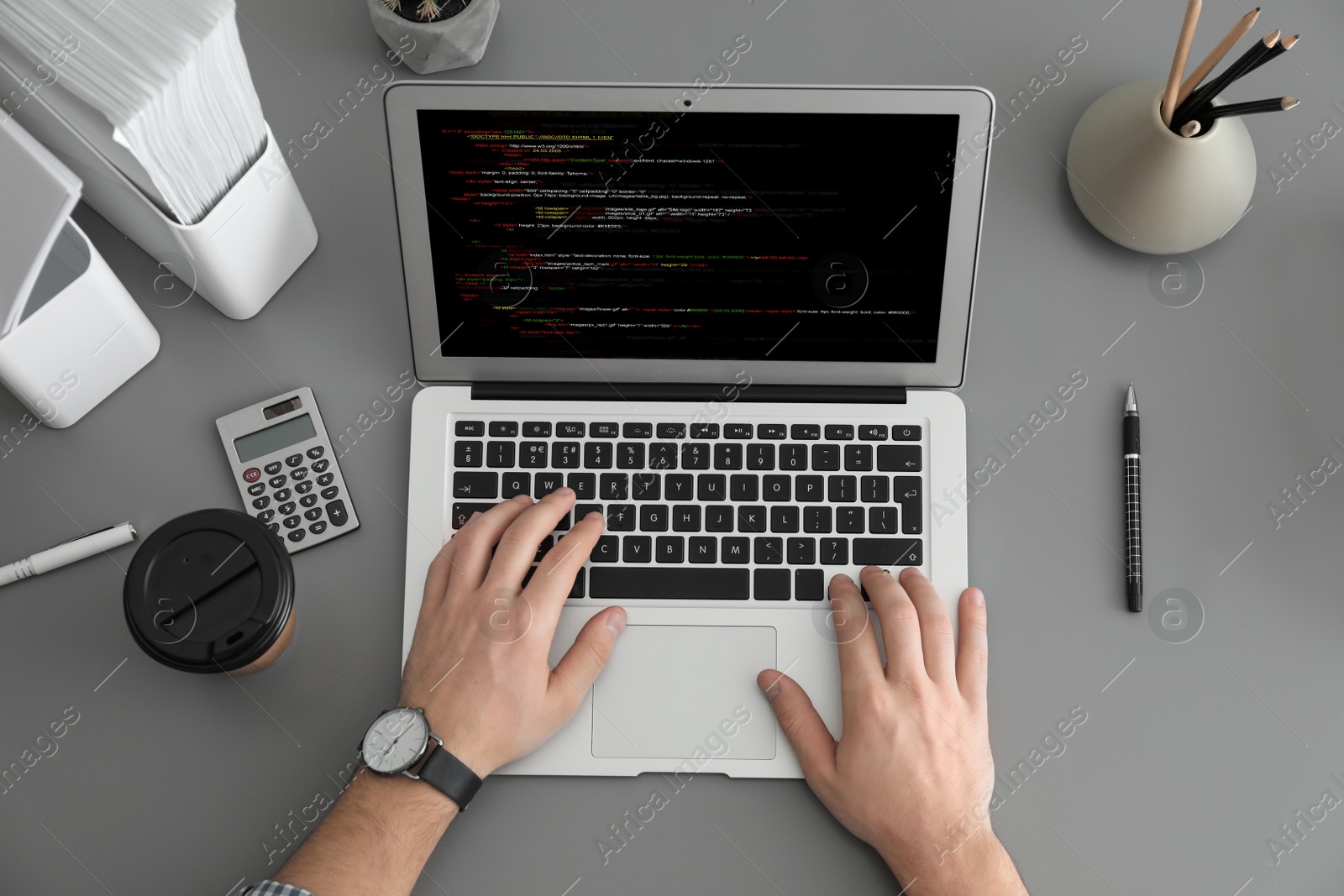 Image of Professional programmer working with laptop at table, top view
