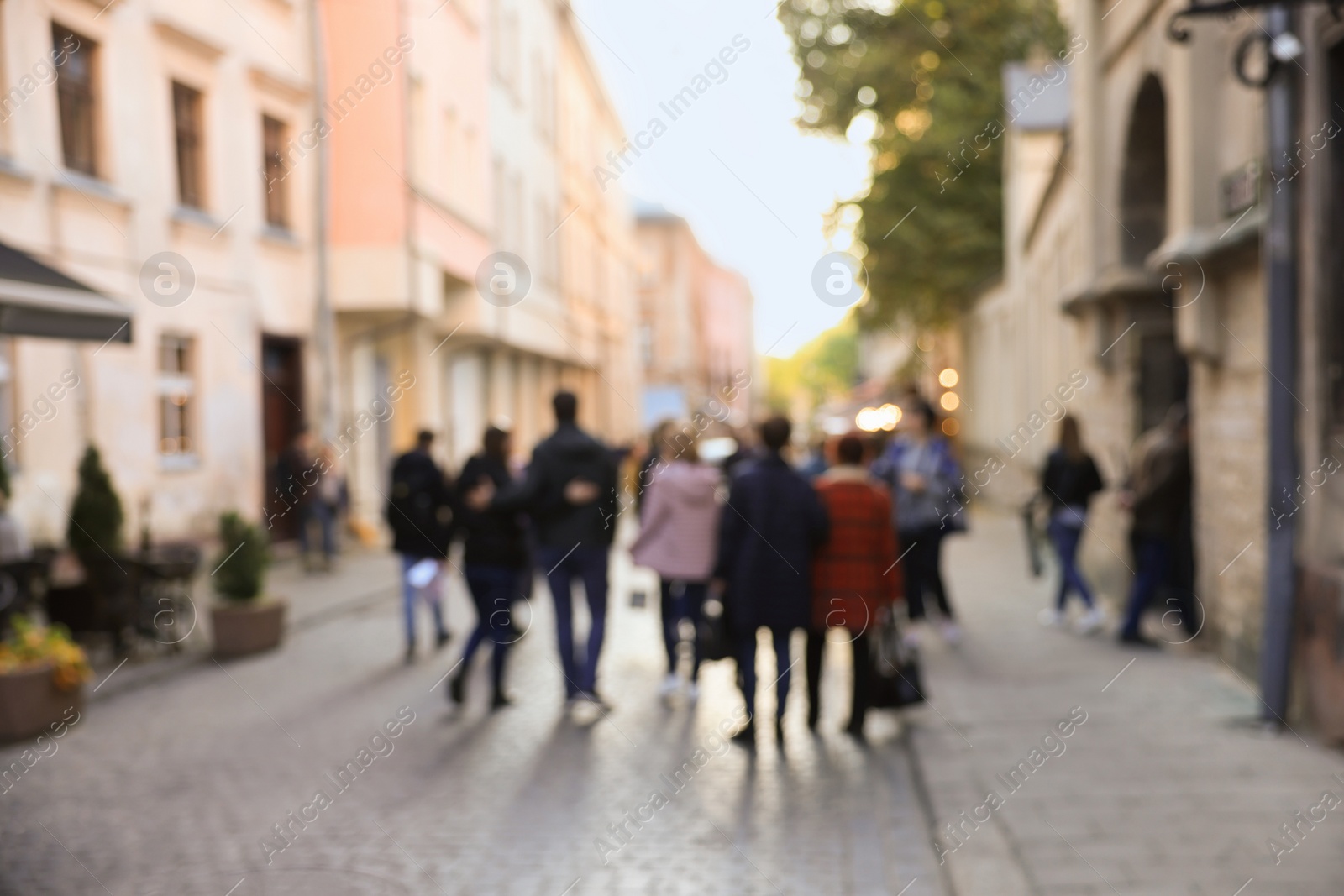 Photo of Blurred view of people walking on city street