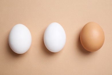 Photo of Chicken eggs on beige background, flat lay