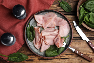 Tasty ham served on wooden table, flat lay