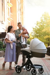 Happy parents walking with their baby outdoors