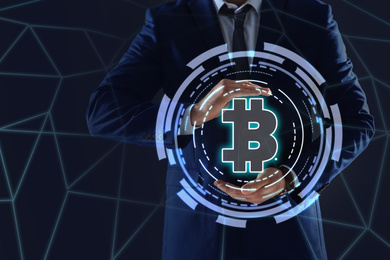 Image of Fintech concept. Businessman demonstrating scheme with bitcoin symbol
