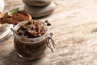 Jar with handmade natural body scrub on wooden background