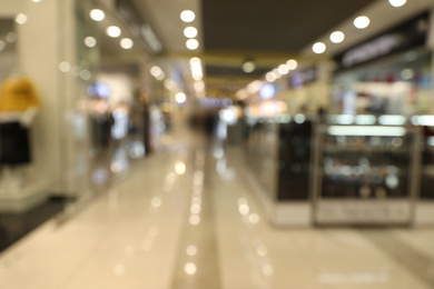 Photo of Blurred view of modern shopping mall interior. Bokeh effect