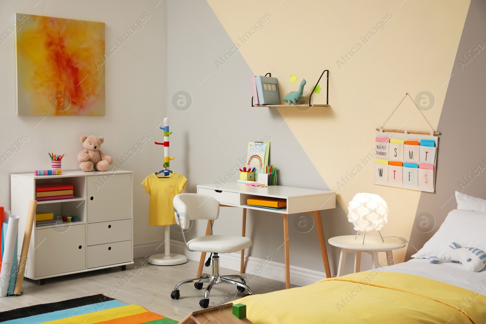 Photo of Stylish child room interior with comfortable bed and desk