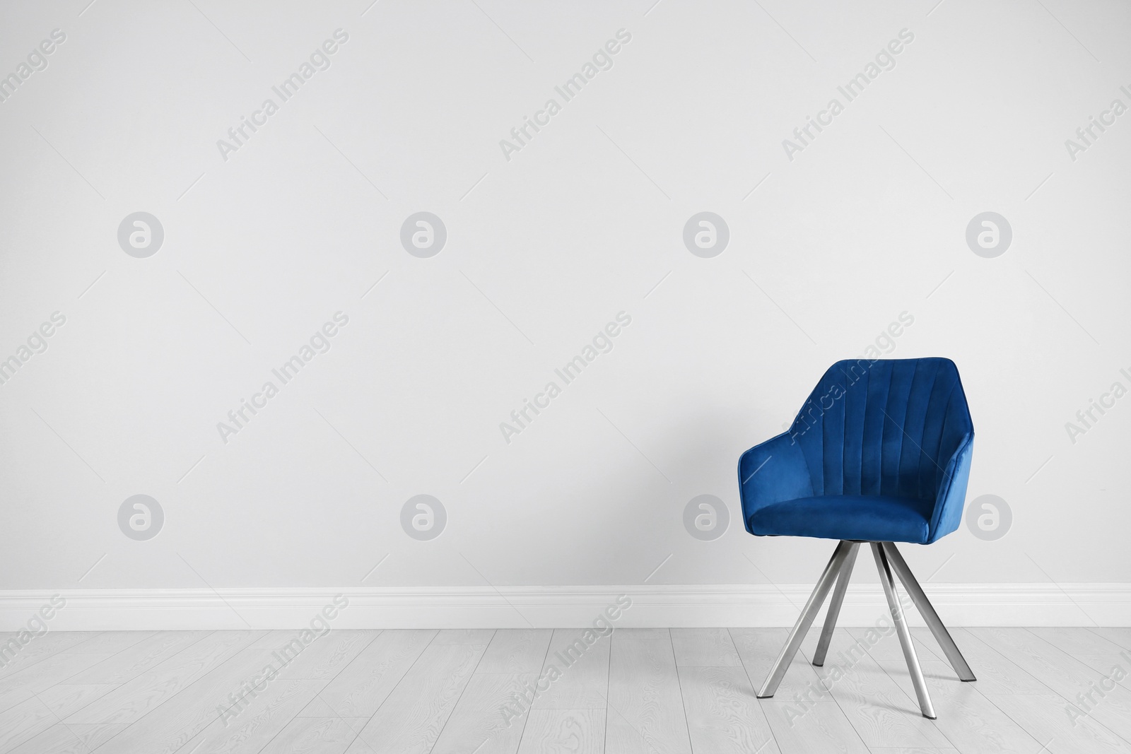 Photo of Blue modern chair for interior design on wooden floor at white wall