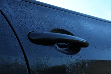 Photo of Wet car with door handle outdoors, closeup view
