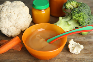 Photo of Healthy baby food and vegetables on wooden table