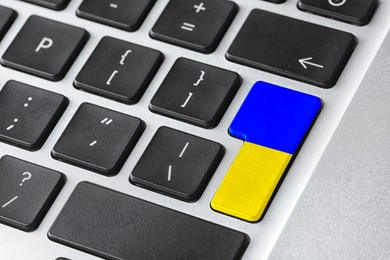 Button in colors of Ukrainian flag on keyboard, closeup view
