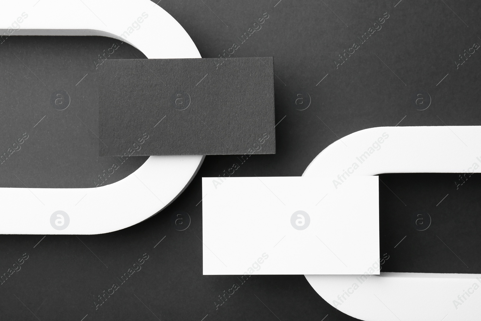 Photo of Stylish presentation of blank business cards on black background, flat lay. Mockup for design