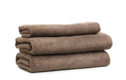 Stack of clean folded towels on white background