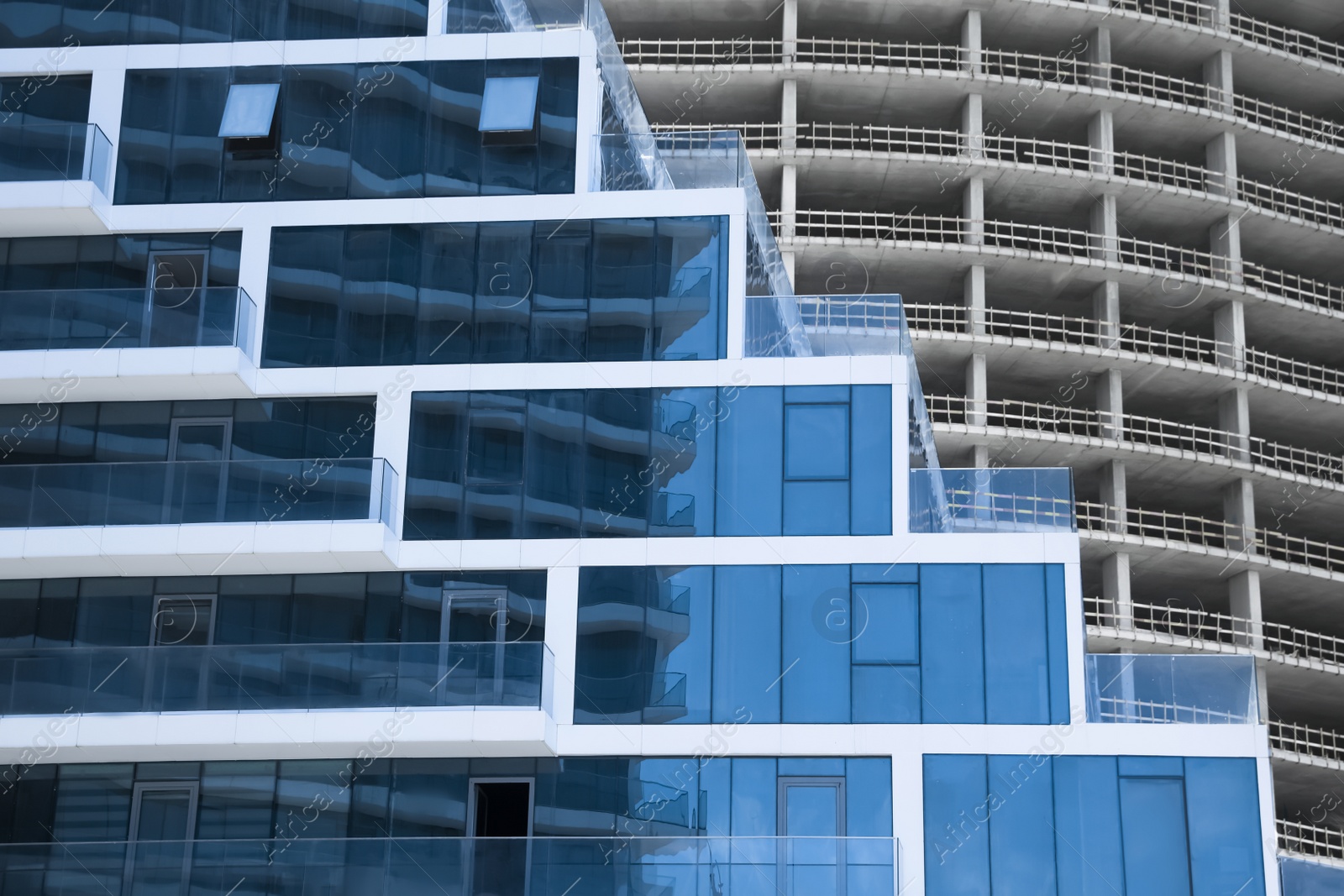 Photo of Modern and unfinished buildings outdoors. Construction site