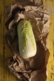 Photo of Fresh ripe Chinese cabbage on yellow wooden table, top view