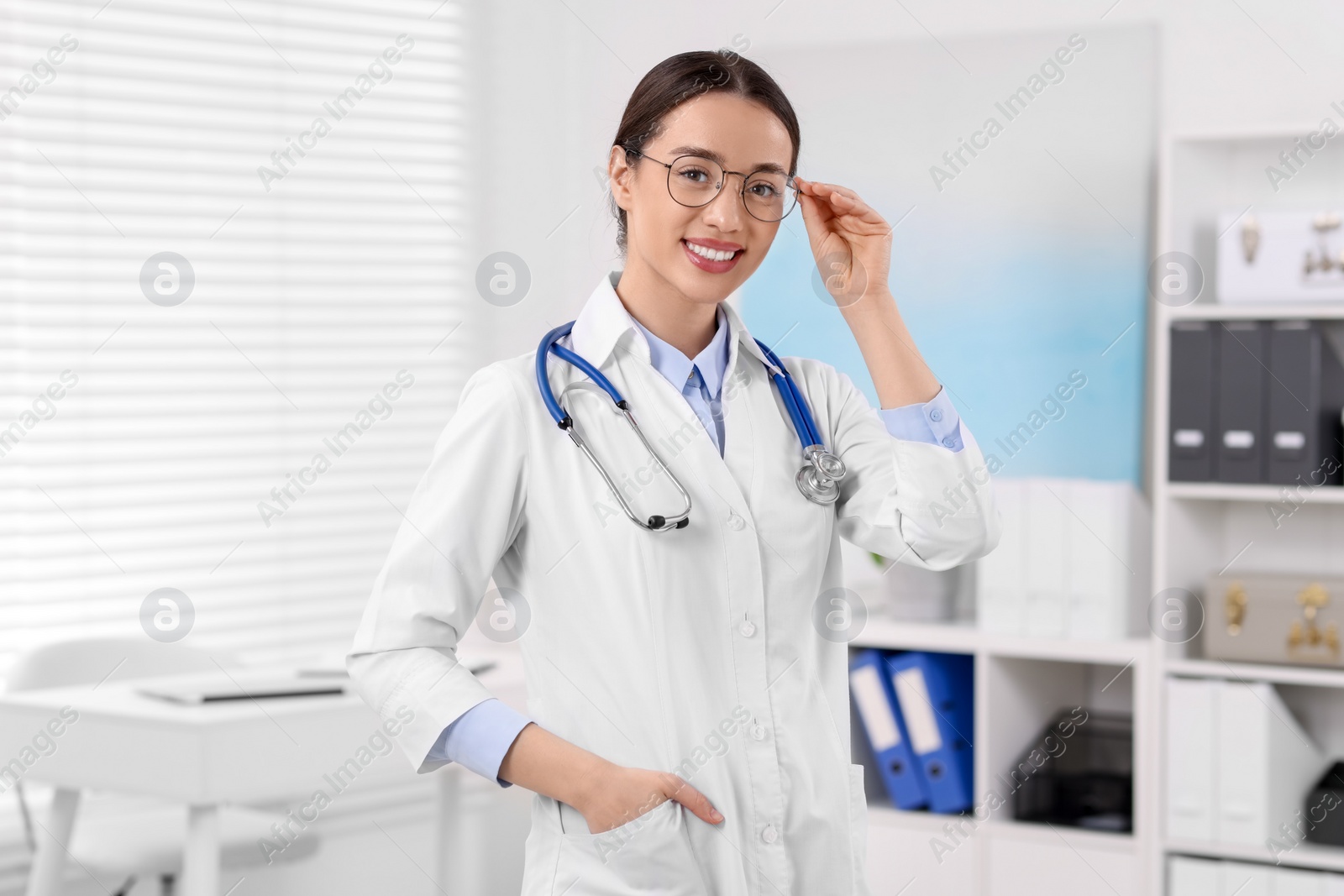 Photo of Medical consultant with glasses and stethoscope in clinic