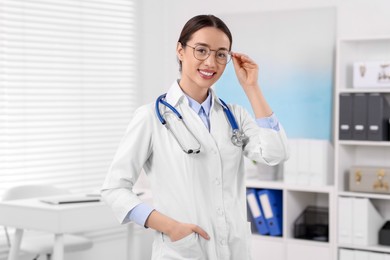 Photo of Medical consultant with glasses and stethoscope in clinic