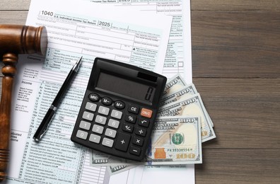 Tax law. Flat lay composition with gavel and forms on wooden table