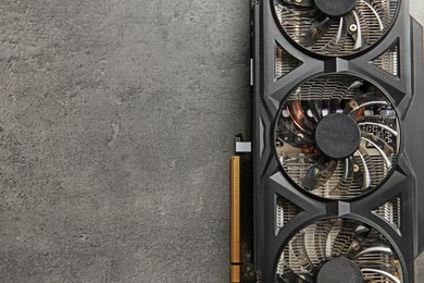 One computer graphics card on grey textured table, top view. Space for text