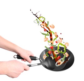 Image of Man tossing ingredients in wok on white background, closeup