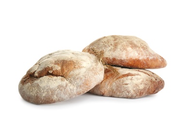 Photo of Loaves of delicious fresh bread on white background