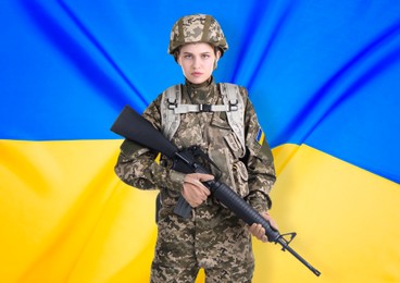 Image of Armed soldier in military camouflage uniform and Ukrainian flag on background. Stop war
