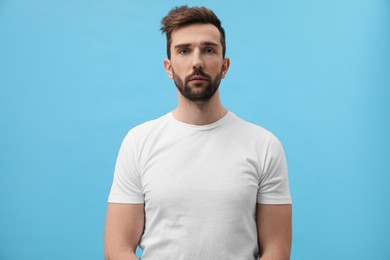 Photo of Portrait of handsome man on light blue background