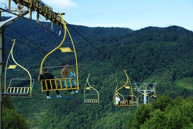 Photo of Chairlift with seats at beautiful mountain resort