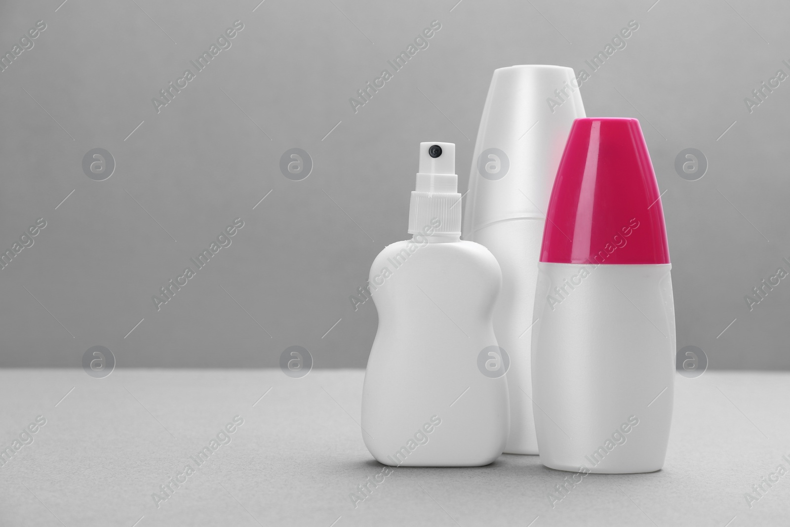 Photo of Set of different insect repellents on grey background. Space for text
