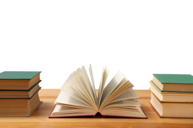Photo of Many books on wooden table against white background. Library material