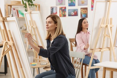 Photo of Women attending painting class in studio. Creative hobby