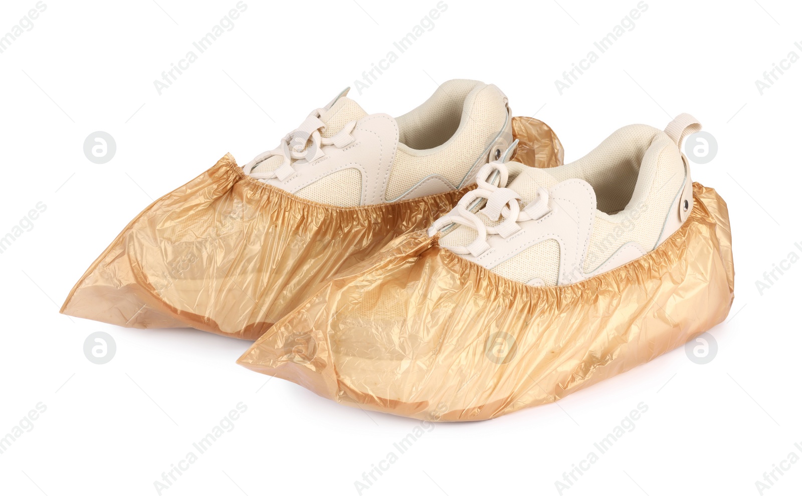 Photo of Sneakers in brown shoe covers isolated on white