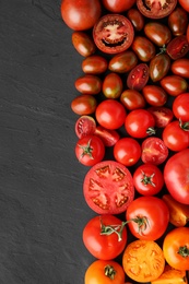 Flat lay composition with fresh ripe tomatoes on black background