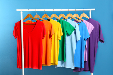 Bright clothes on blue background. Rainbow colors