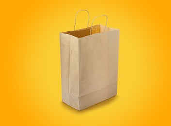 Kraft paper bag on yellow background. Mockup for design