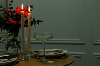 Photo of Romantic table setting with candles and flowers, space for text