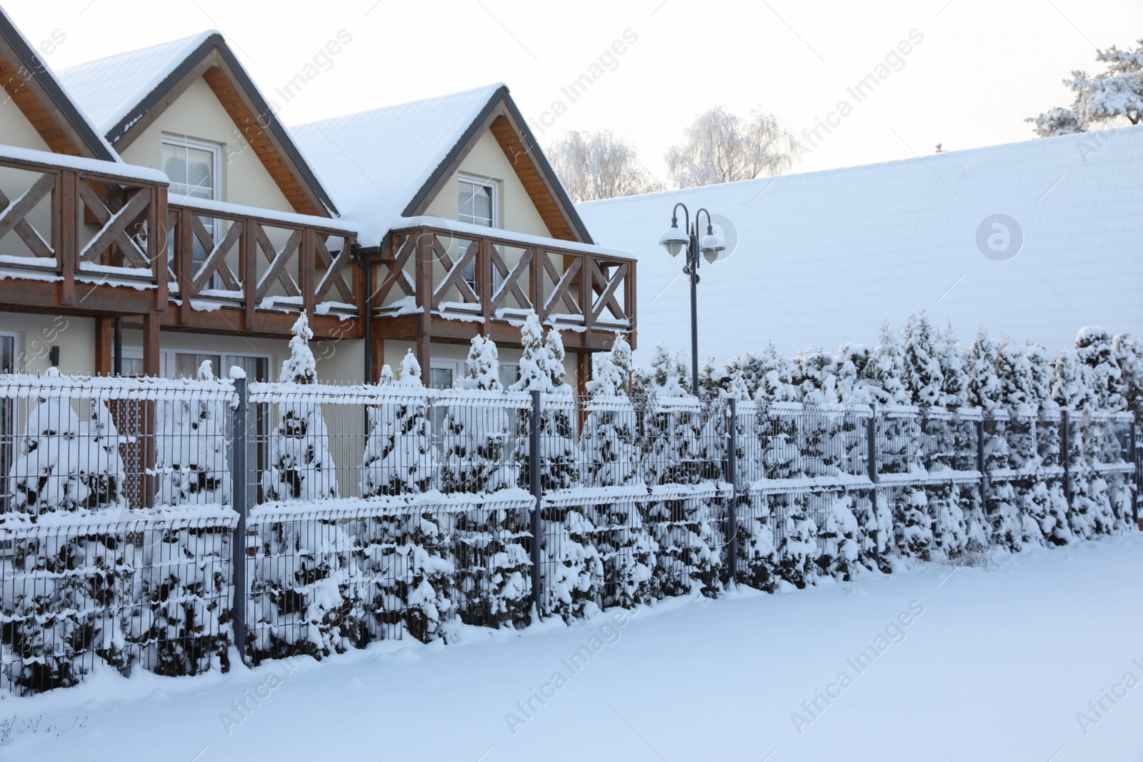 Photo of Winter landscape with modern houses and trees in morning