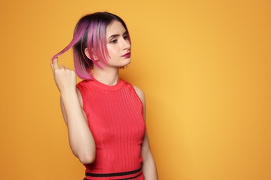 Photo of Young woman with trendy hairstyle against color background