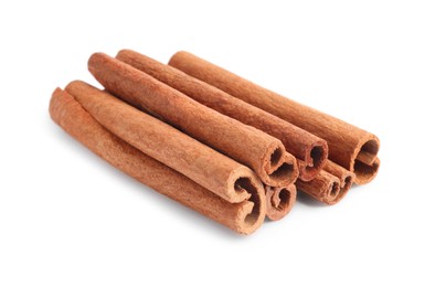 Photo of Pile of aromatic cinnamon sticks isolated on white