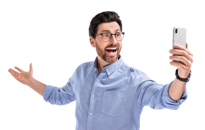 Photo of Smiling man taking selfie with smartphone on white background