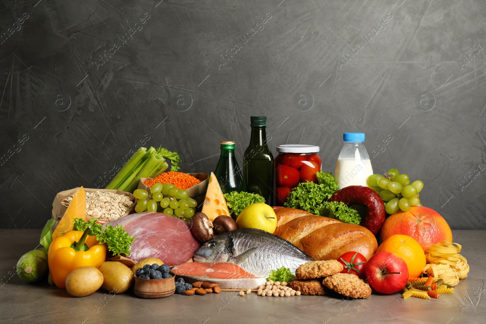 Photo of Different products on grey table. Healthy food and balanced diet