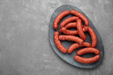 Delicious sausages on grey table, top view. Space for text